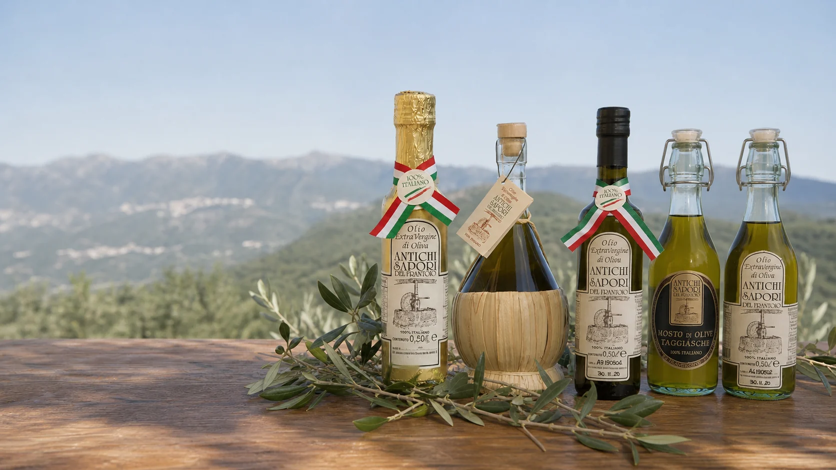 Selezione di bottiglie e fiaschetta di olio riunite in un'unica ambientazione ligure